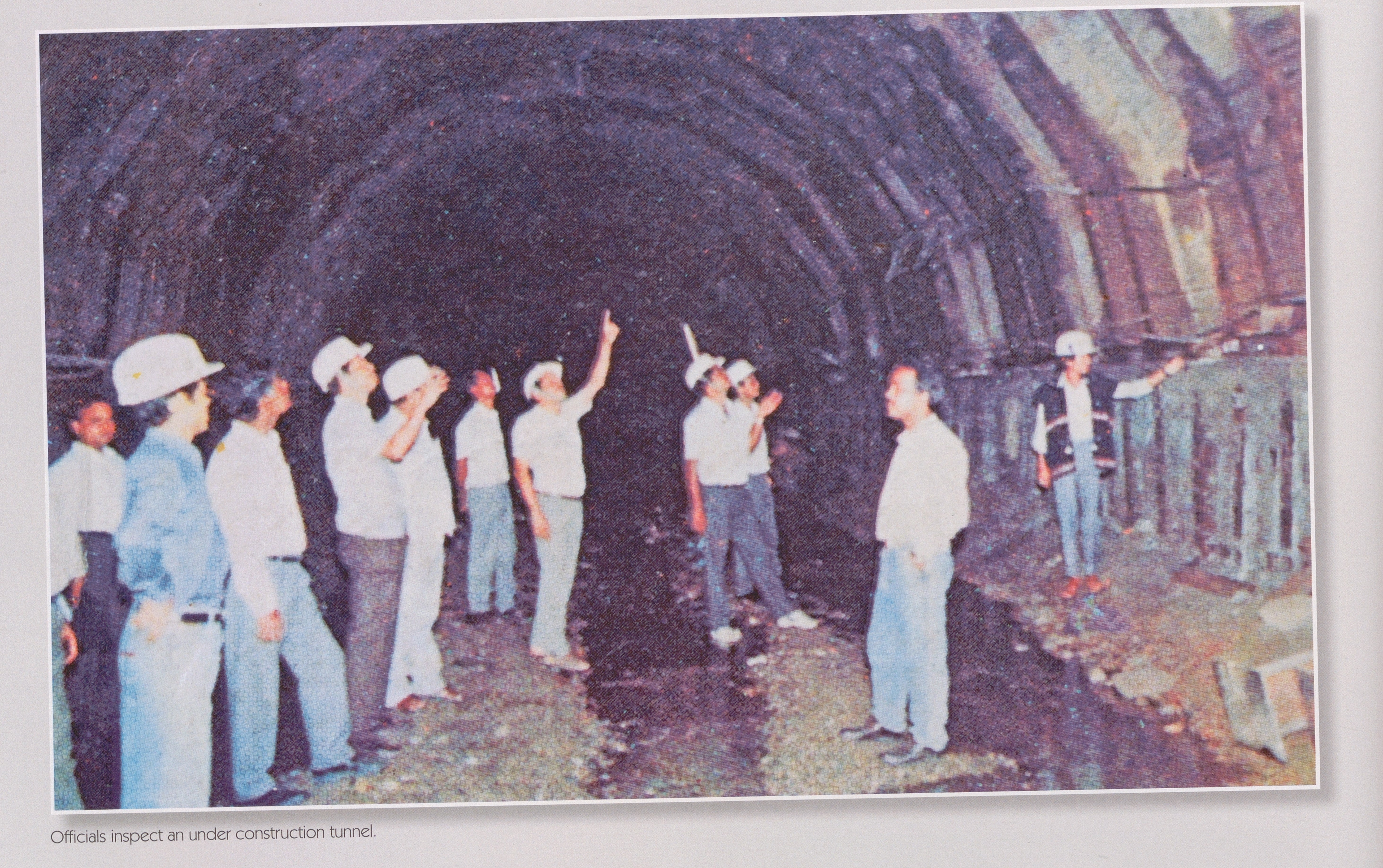 Officials inspect an under construction tunnel