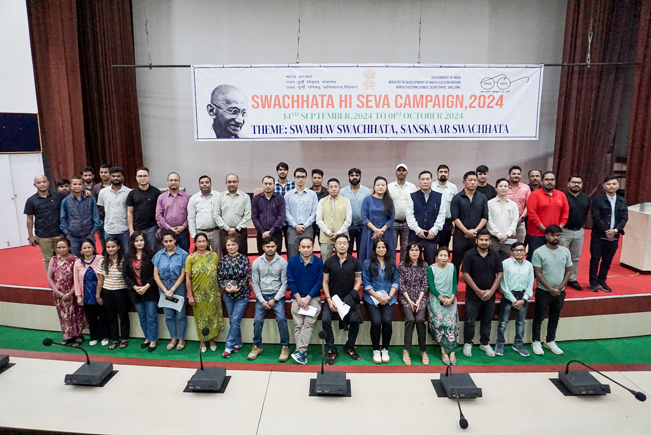 NEC staff posing for a group photograph after the oath-takin