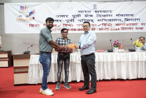 Planning Adviser Som Kamai honoring the winners