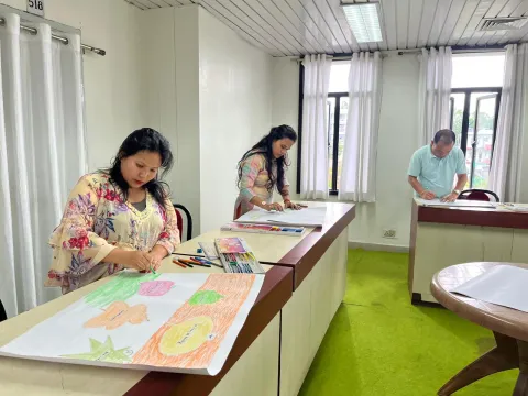 NEC officials participating in the poster-making competition